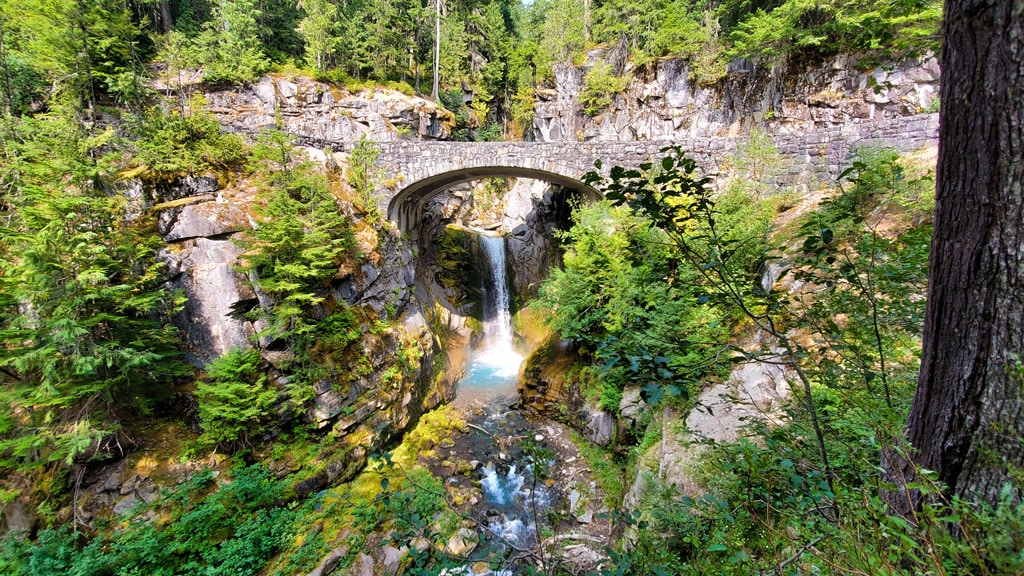 Christine Falls at Mount Rainier National Park in the summer with lush green and trees